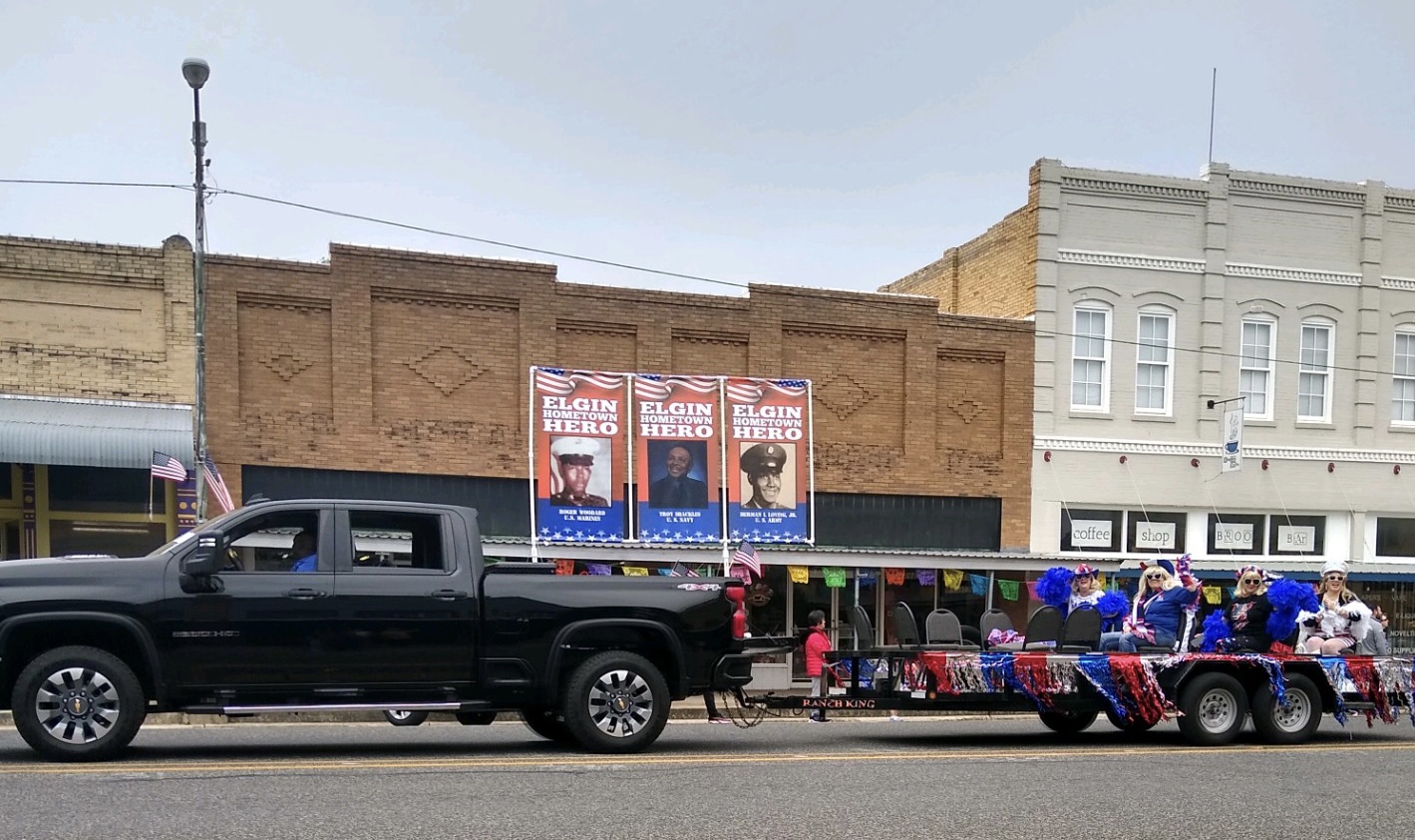 After banners were displayed downtown for Memorial Day, family members proudly displayed them in November for Elgin’s Veteran’s Day Parade.